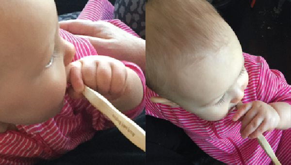 Baby chewing on bristles of a Brush With Bamboo toothbrush